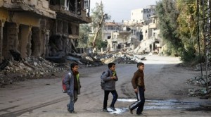 Syrian children cross a street as they head to their school in the northeastern city of Deir Ezzor on January 23, 2014. Nearly 1,400 people have been killed in Syria since clashes between rebel forces and the jihadist Islamic State of Iraq and the Levant erupted this month, a monitor said. AFP PHOTO/AHMAD ABOUD